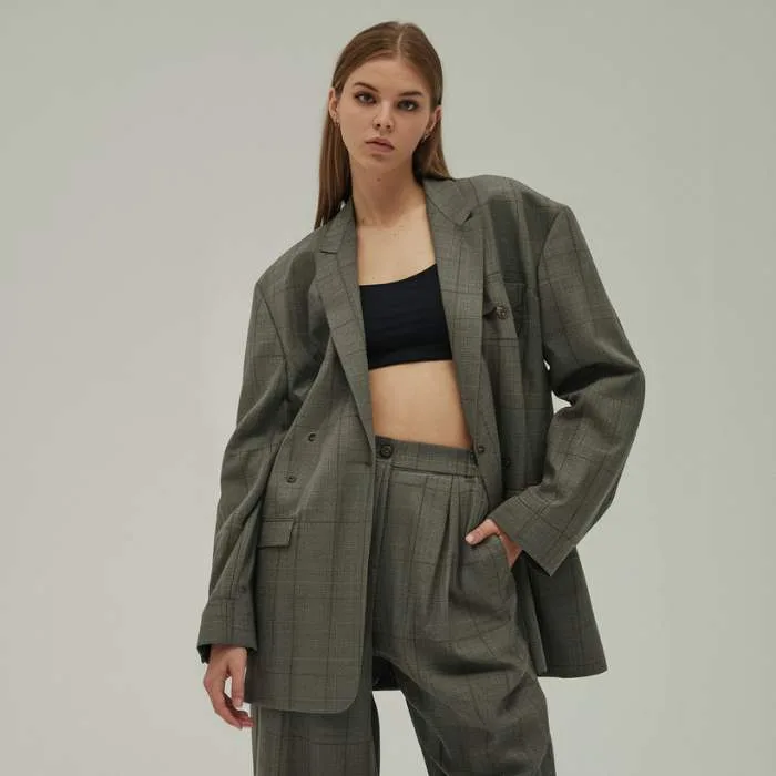 Command attention with oversized power suits featuring exaggerated shoulders and flowing trousers.