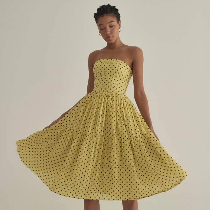 Strapless dresses with fun patterns like polka dots are making a stylish comeback this spring.
