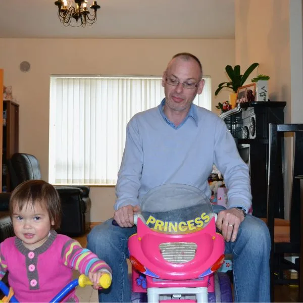 Dad and daughter playing together, showing love and joy from 18 years of marriage advice