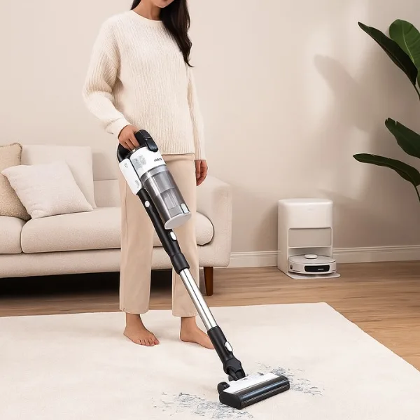 Mindful home organization — woman using cordless stick vacuum to clean rug in a cozy and organized living room.